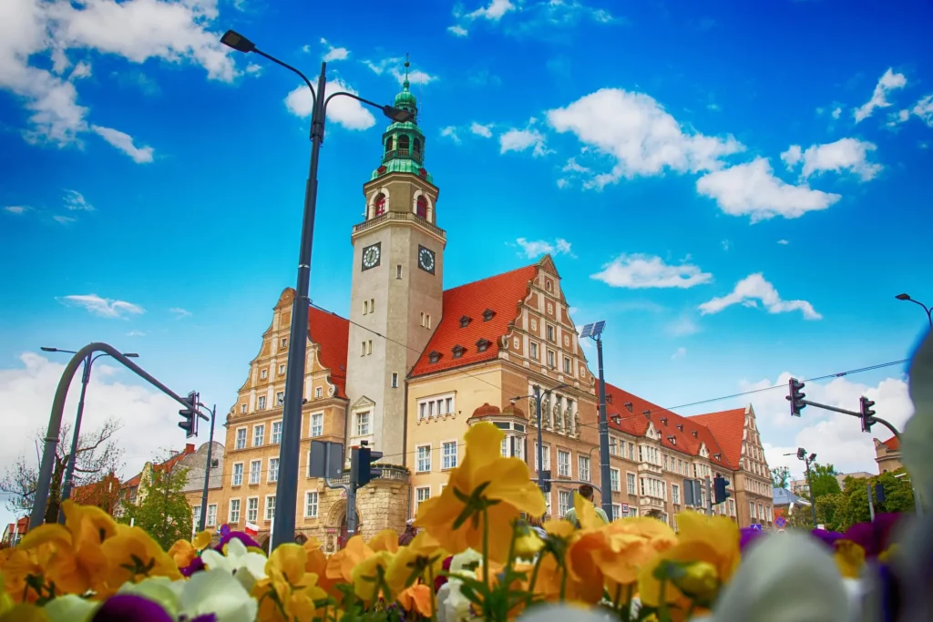 Nuevo Ayuntamiento de Olsztyn con su torre del reloj y flores en primer plano